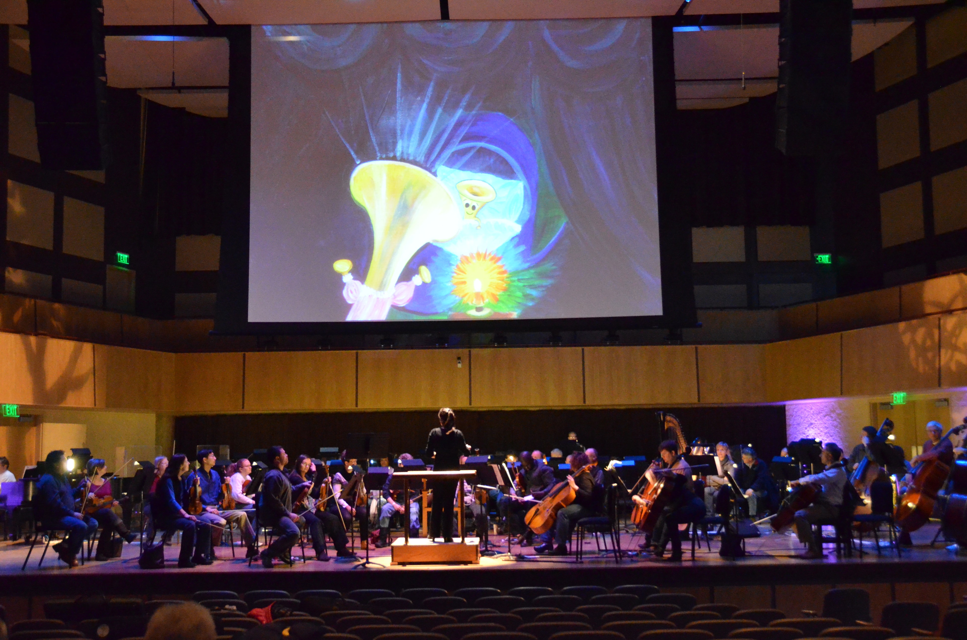 Orchestra performing beneath Crumpet the Trumpet artwork